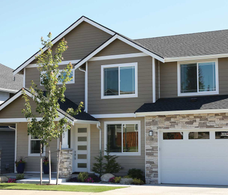 A new build home with siding on the upper floor.