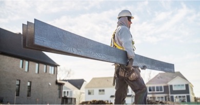 man carrying boards