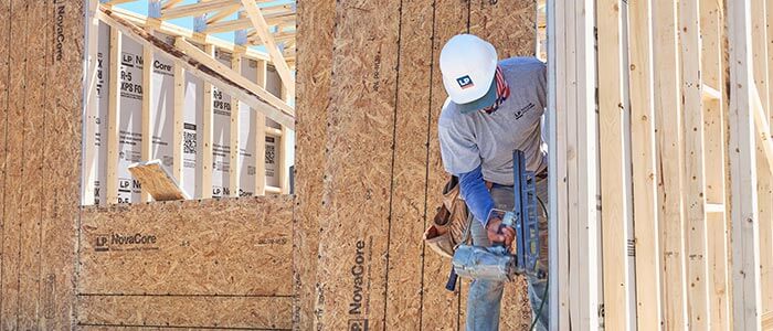 Installer nailing NovaCore board to framing