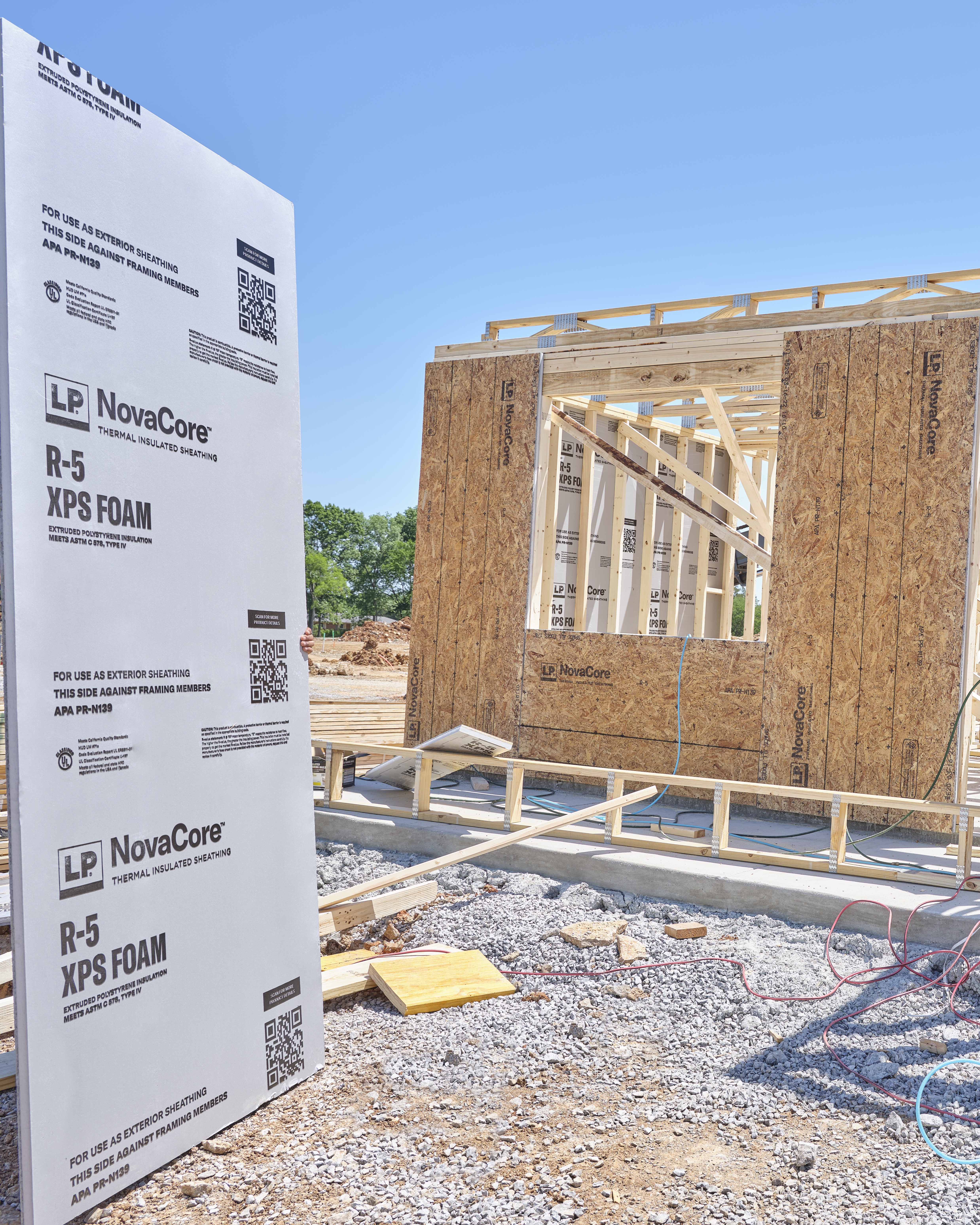 a panel of LP novacore with a frame house wall in the background