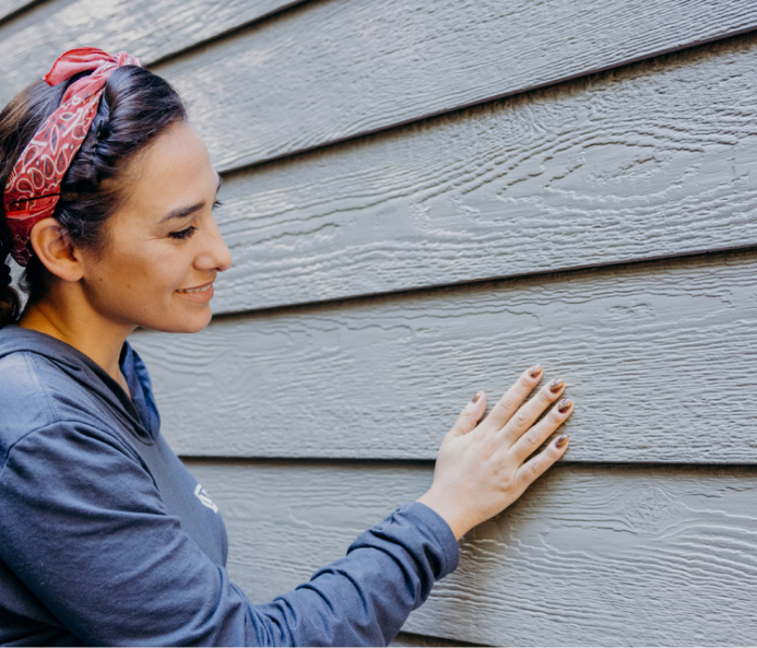 Woman inspecting lp smartside siding